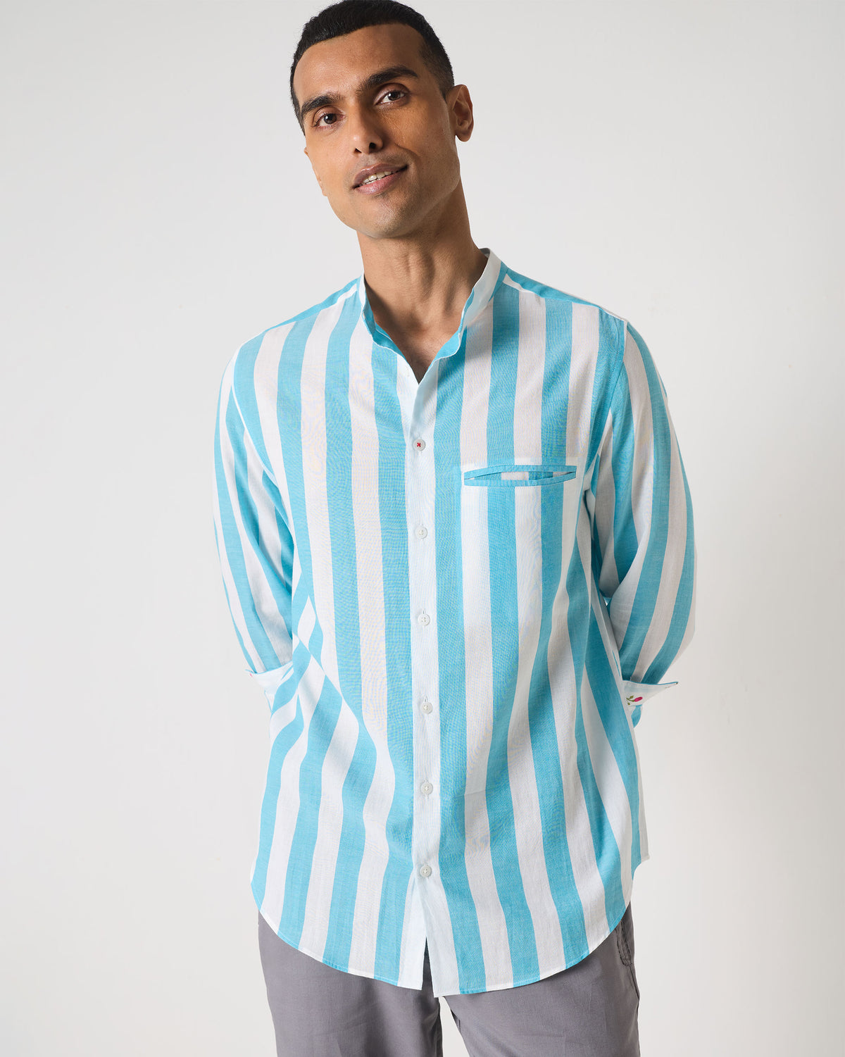 Person wearing a blue and white striped Slim Fit Shirt with a welt pocket.