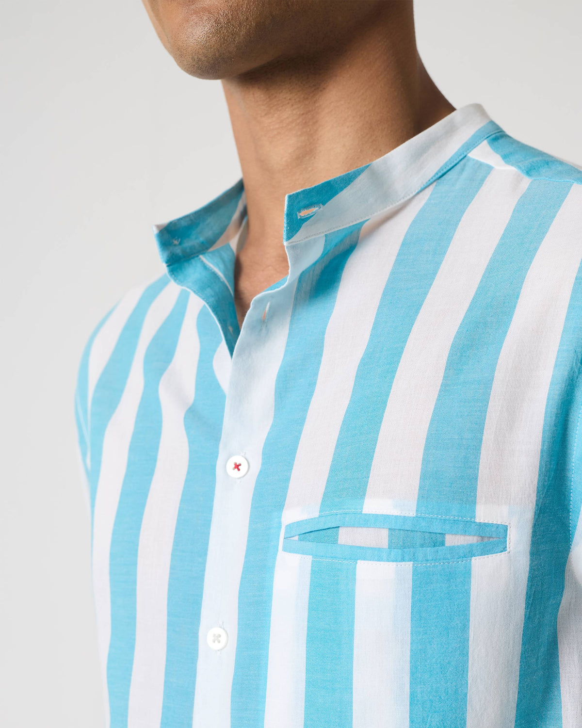 Close-up of a blue striped Slim Fit Shirt collar and welt pocket.