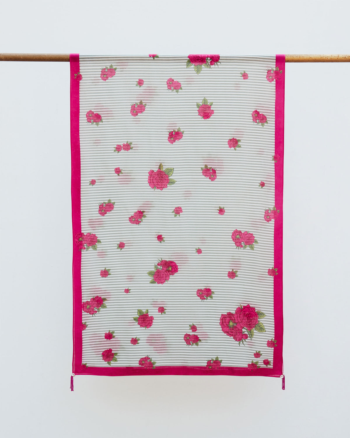Stripes and Flowers Scarf hung from a rod, showing grey stripes and pink roses.