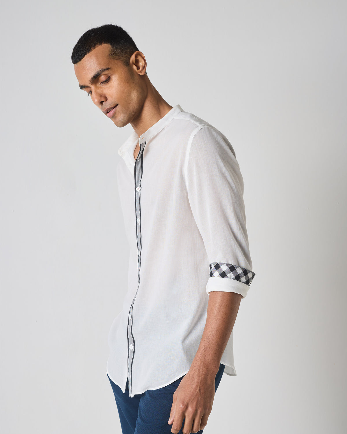 White Neil shirt with striped placket trim and rolled gingham cuffs.