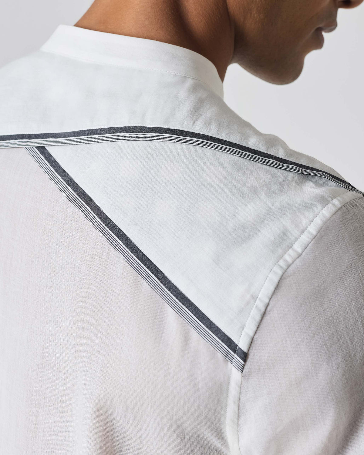 Close-up of the back yoke trim on a white Neil shirt.
