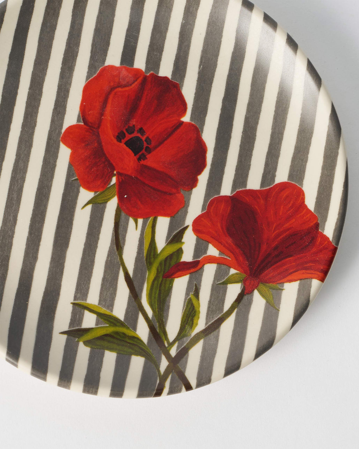 Close-up of red poppies on a Striped Poppy quarter plate.