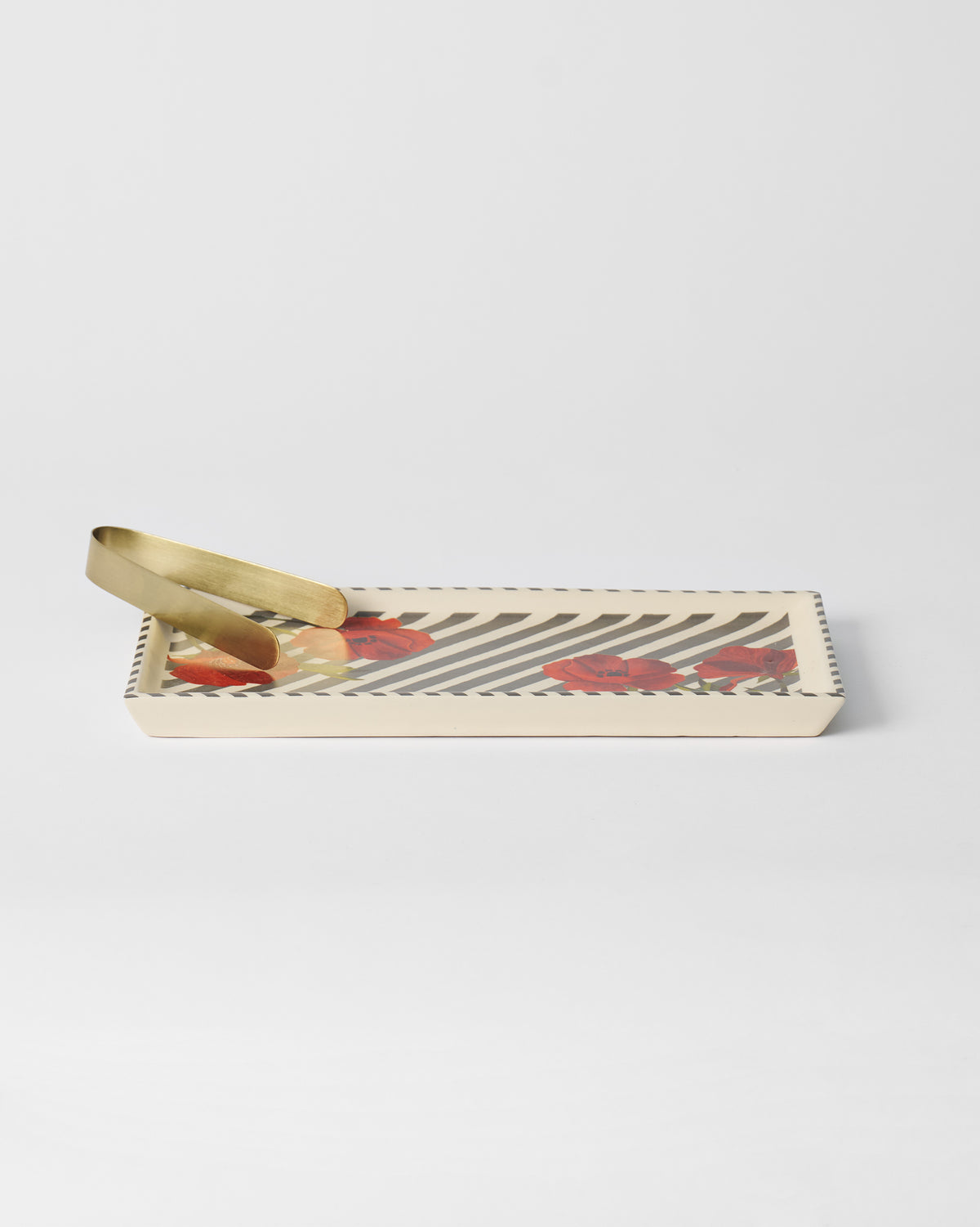 Striped Poppy cookie tray angled to show depth with gold tongs inside.