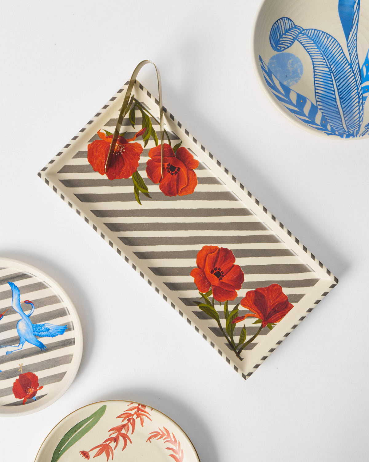 Striped Poppy cookie tray with tongs among coordinating tableware pieces.
