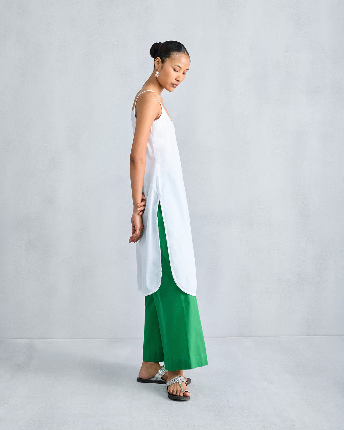 Side view of a white Vintage Camisole showing high side slits.