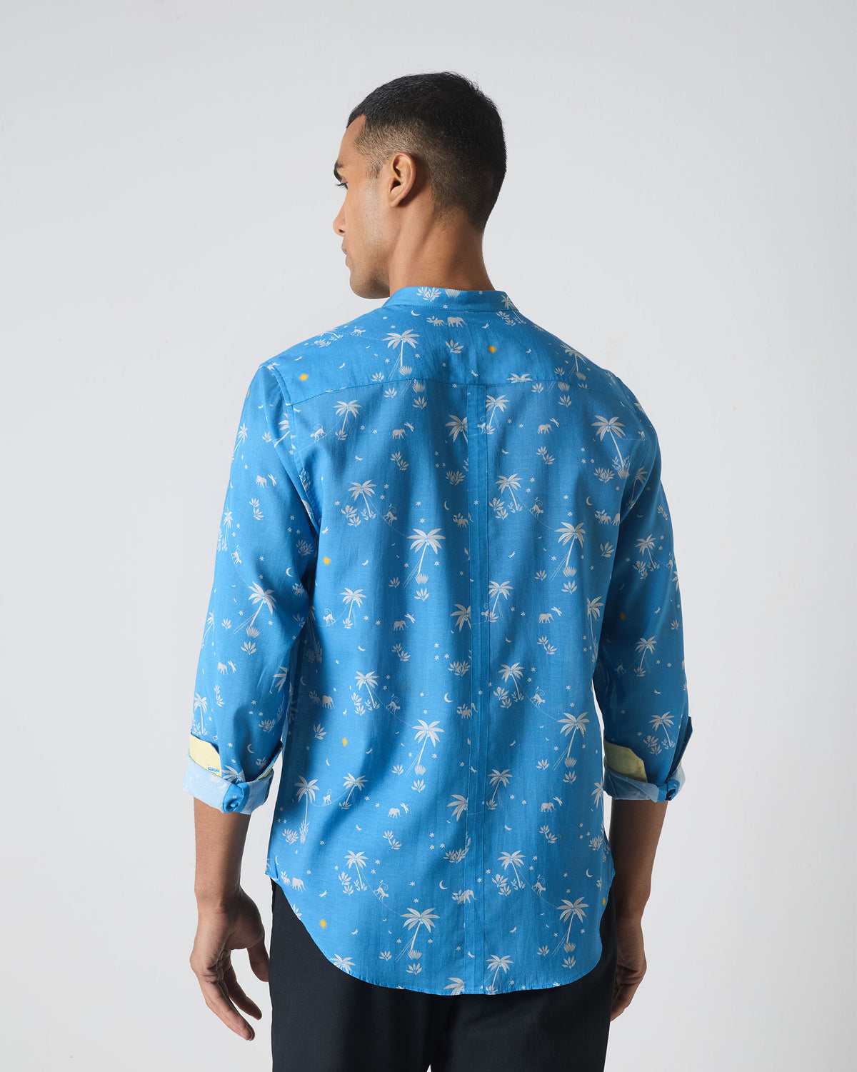 Back of a blue Nawab shirt with white palm print.