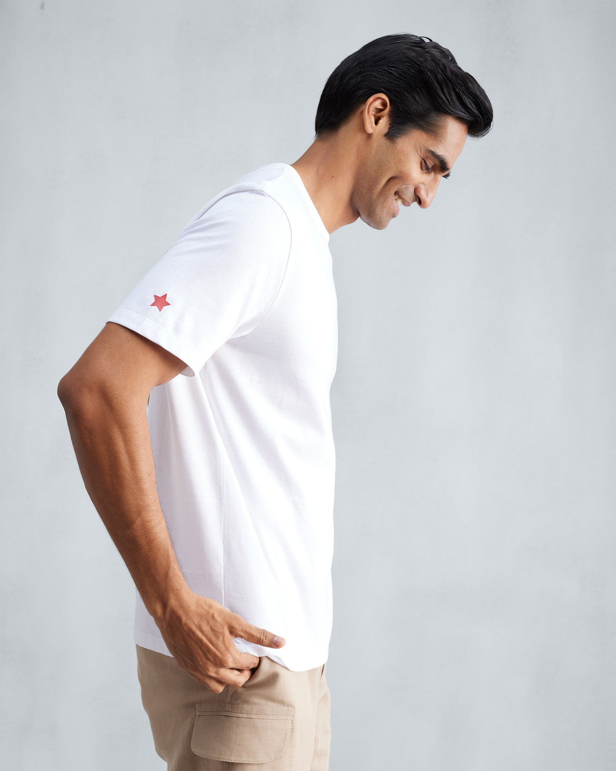 Side view of a white Everyday T-shirt with a red star on the sleeve.