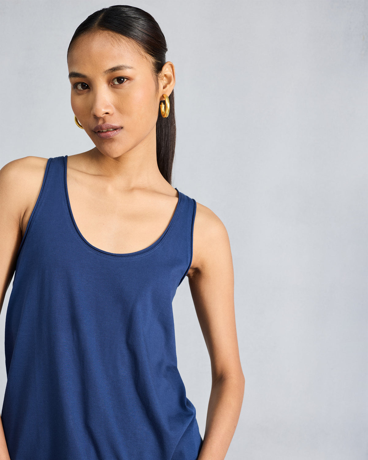 Person wearing a navy sleeveless racerback tank.