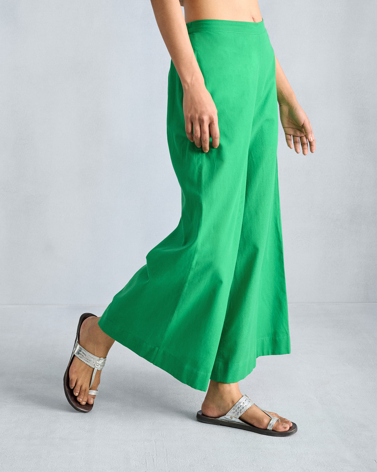Side view of bright green wide-leg pyjamas showing the gentle A-line flare.