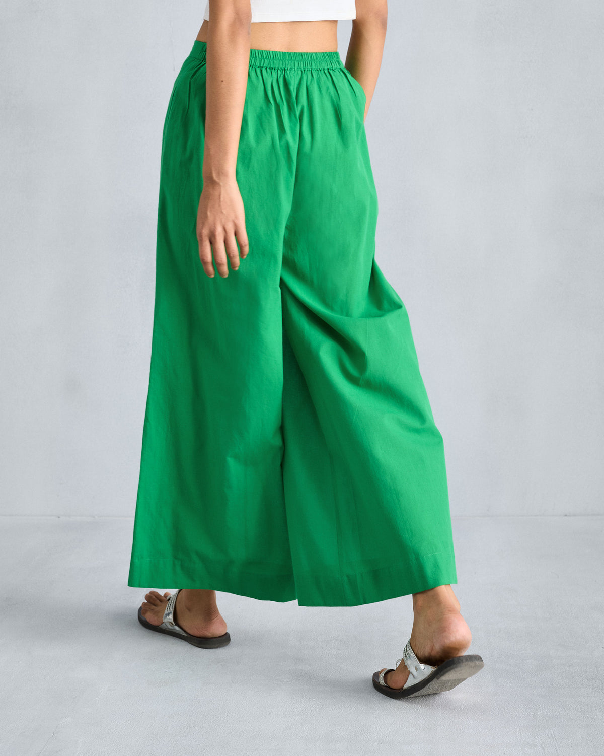 Back of bright green wide-leg pyjamas with a gathered elastic waistband.