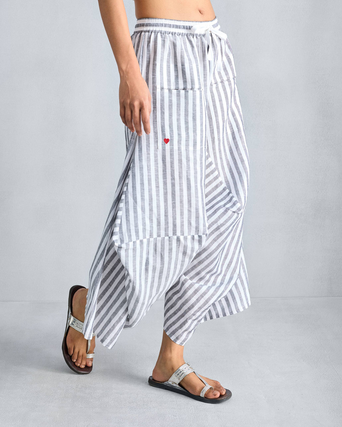 Charcoal and white striped Yoka Trousers with a red heart on the pocket.