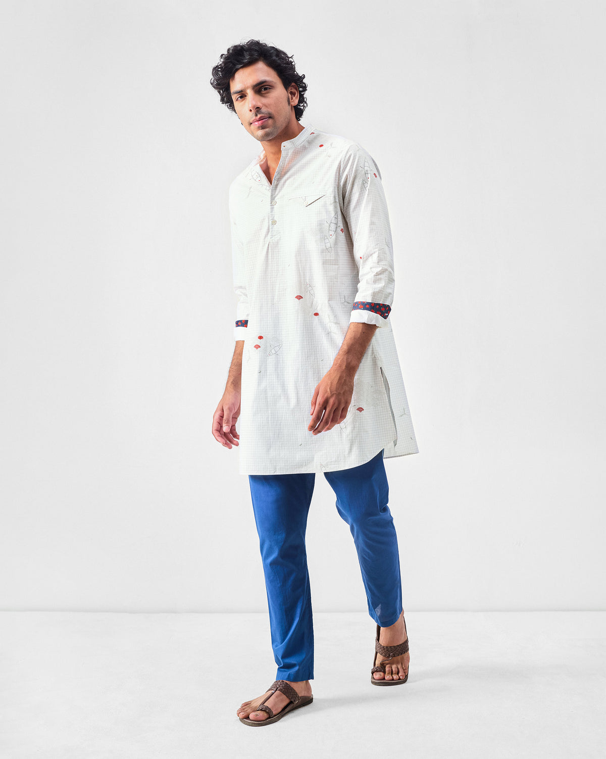 Person wearing a white Fort kurta with boat print and contrasting cuff lining.
