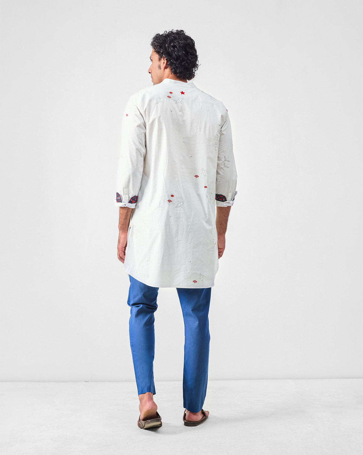 Back of a white Fort kurta with scattered red embroidered motifs.