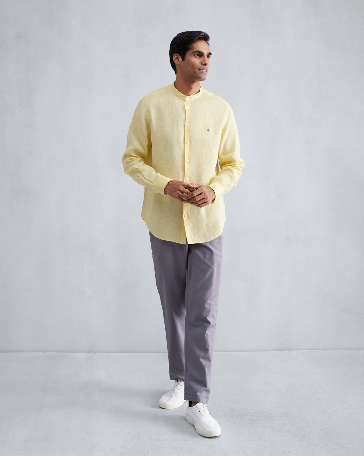 Person wearing a lemon Nawab shirt with a Nehru collar.