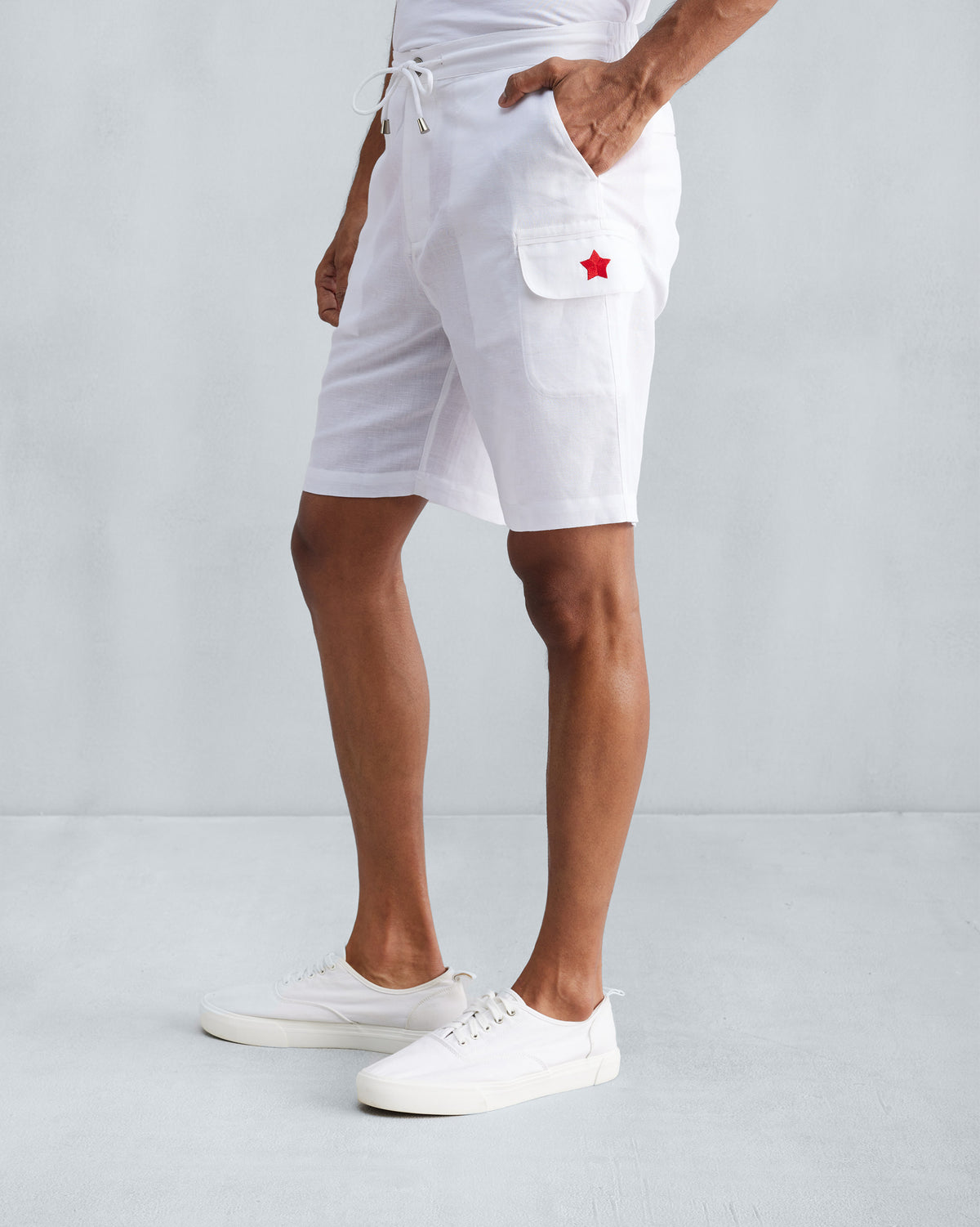 Side view of white Classic Shorts showing the cargo pocket star.