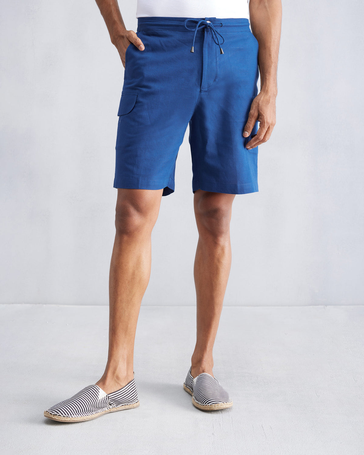 Person wearing navy Classic Shorts with a drawstring waist.