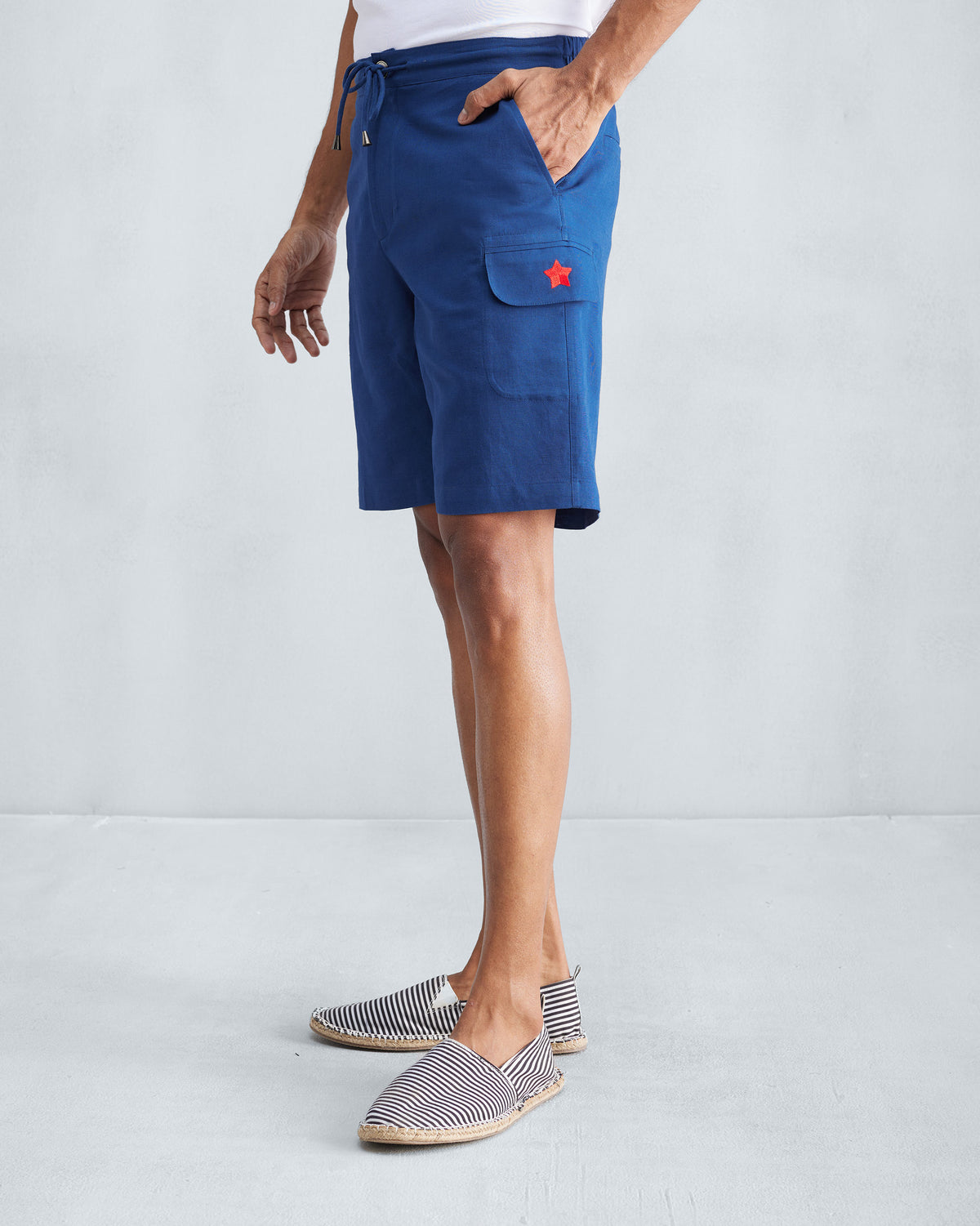 Side view of navy Classic Shorts showing the cargo pocket star.