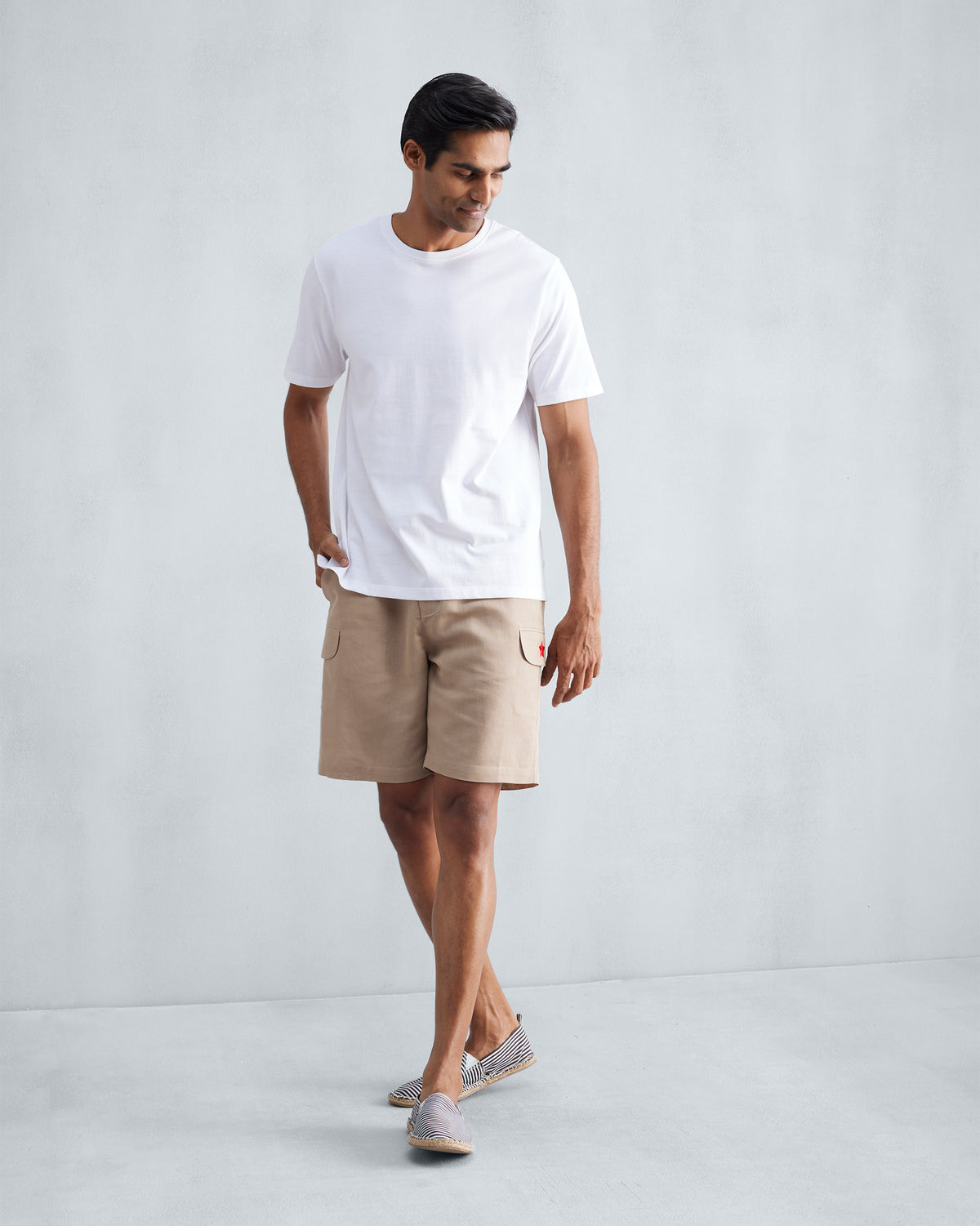 Person wearing beige Classic Shorts with a side cargo pocket.