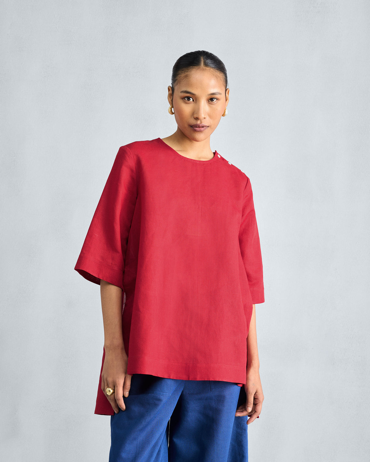 Red High Slit Top with a longer back hem and elbow sleeves.