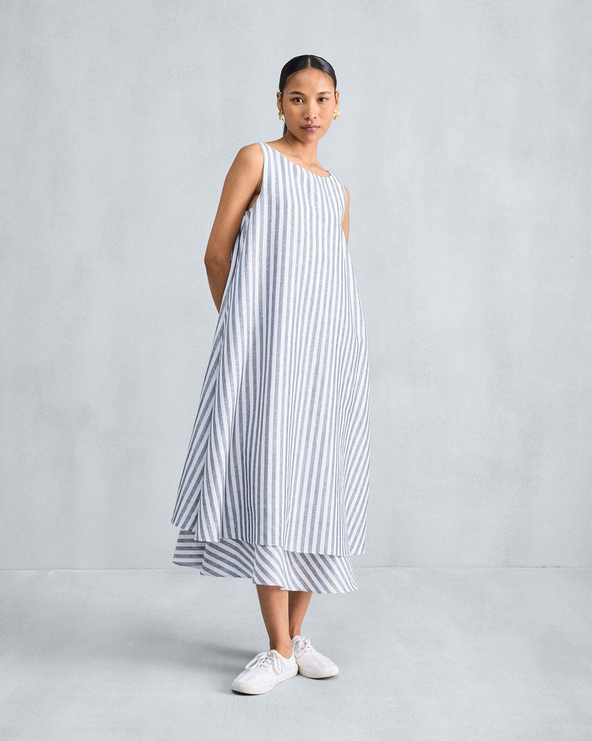 Full-length charcoal and white striped double-layer dress with a tiered hem.