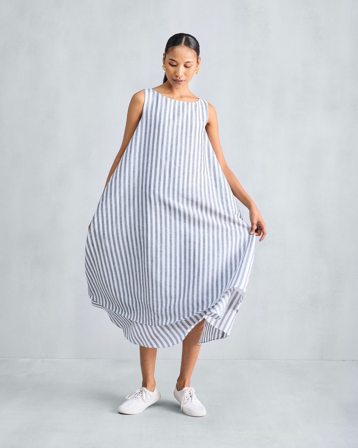 Charcoal and white striped double-layer dress held out to show its volume.