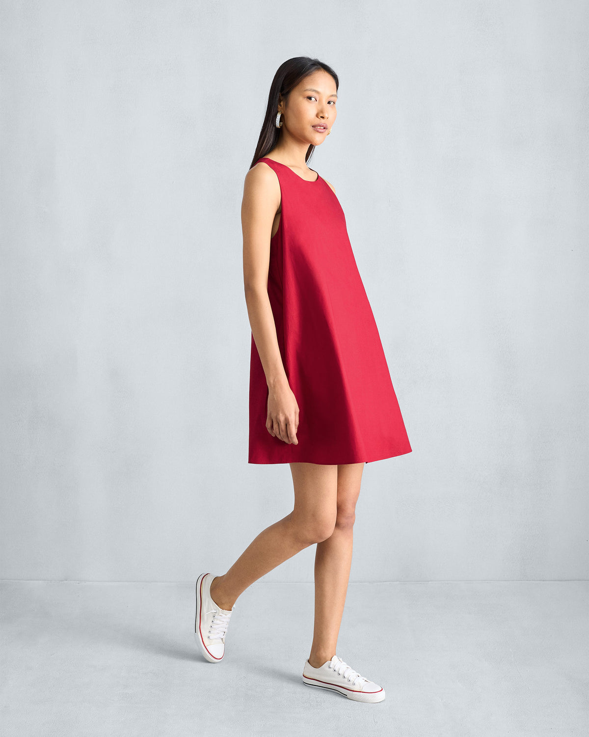 Side view of a red Short Racerback Dress worn by a person.