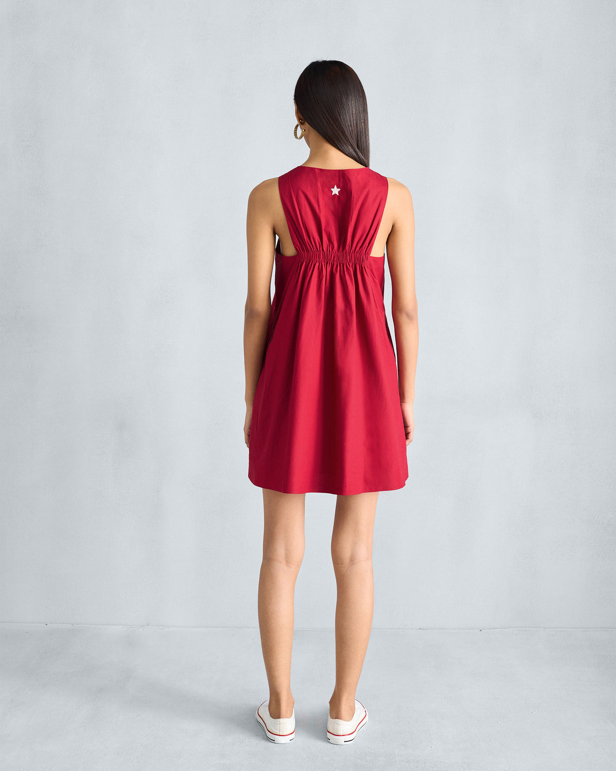 Back of a red Short Racerback Dress worn by a person, showing the gathered band.
