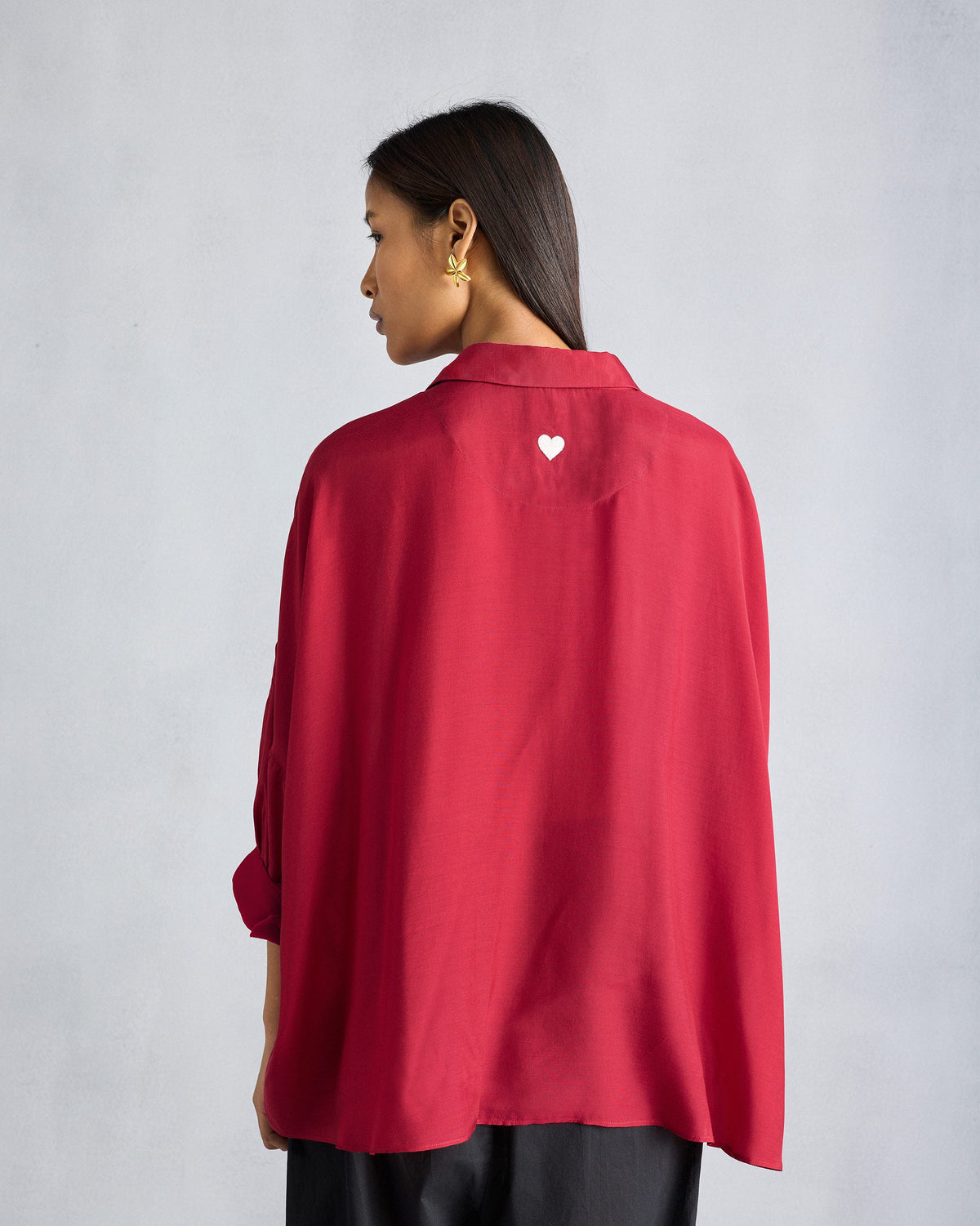 Back of a red Boxy shirt with a white embroidered heart.