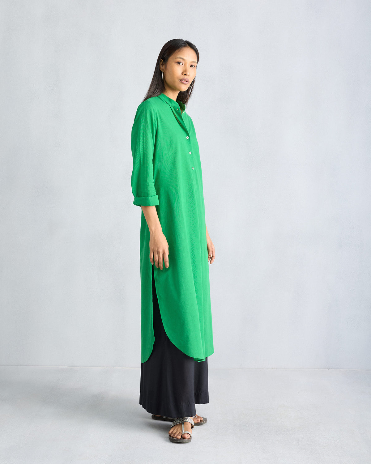 Side view of a green long kurta with deep side slits.