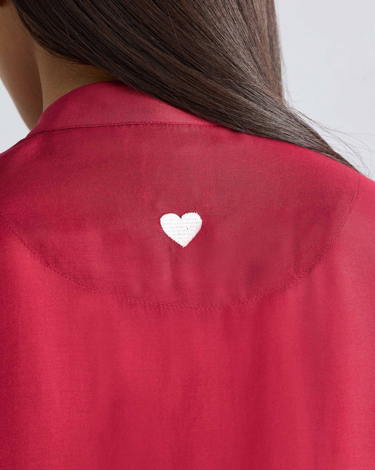 Close-up of a red short sleeve kurta with a white heart on the back.