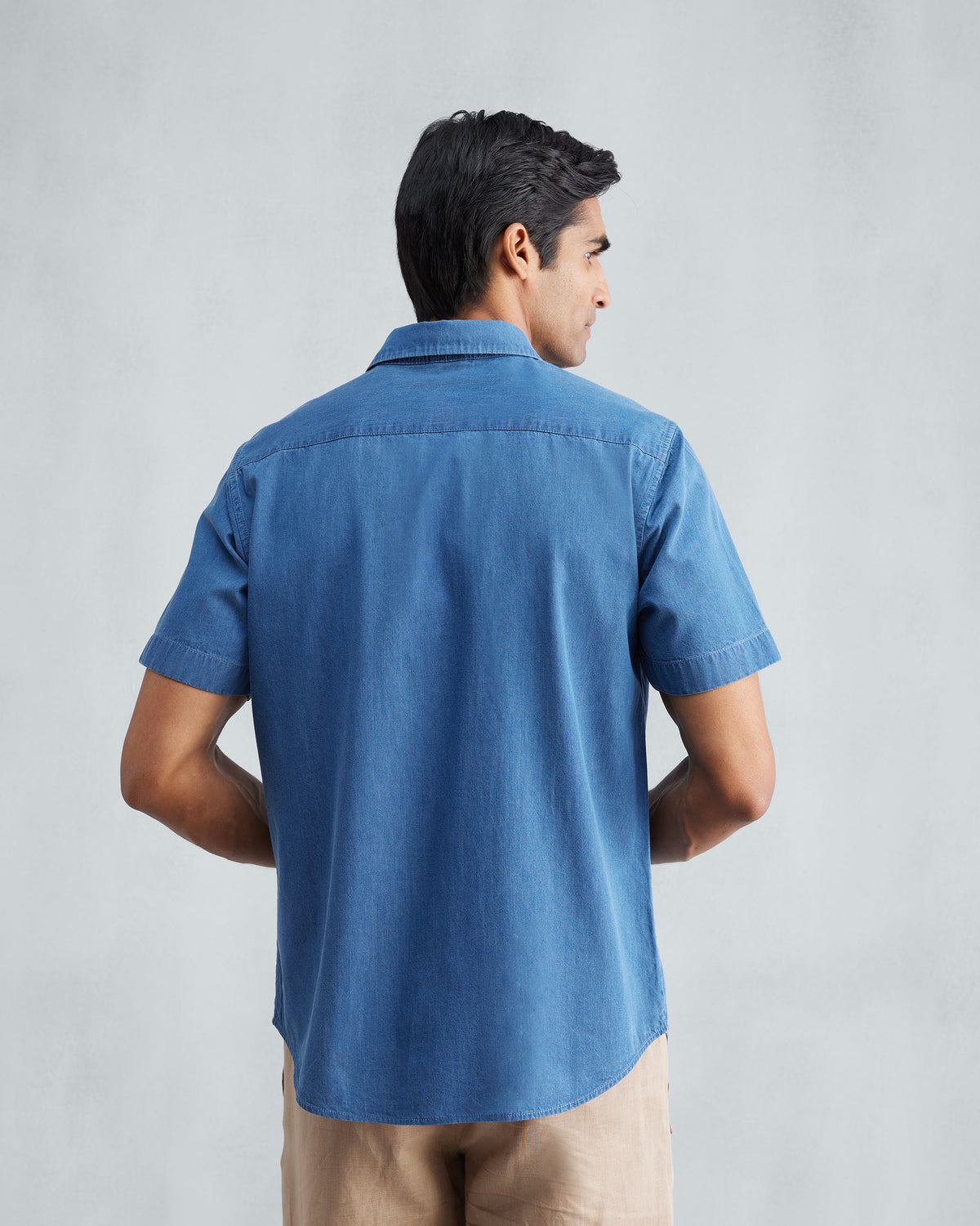 Back of a denim half sleeve shirt showing the shoulder yoke.