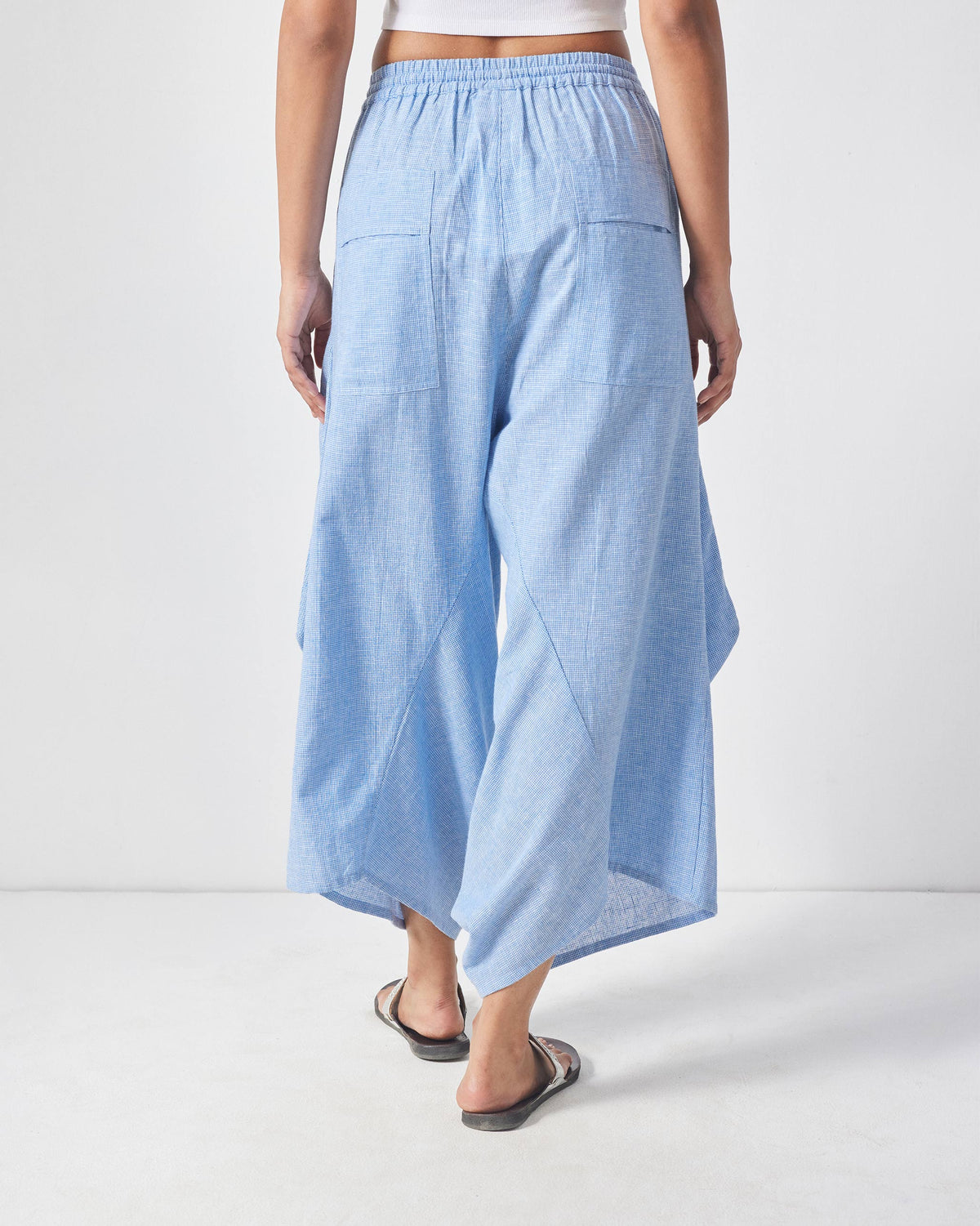 Back of light blue Sakura set trousers with patch pockets.