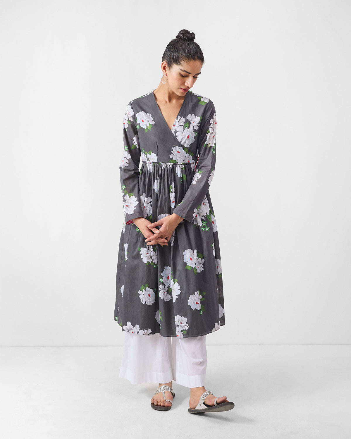 Person wearing a charcoal angrakha with ivory floral print.