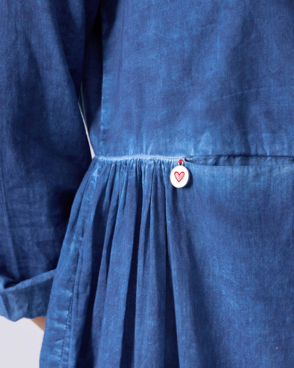 Close-up of a blue Geisha Kurta showing a heart coin motif at the waist.