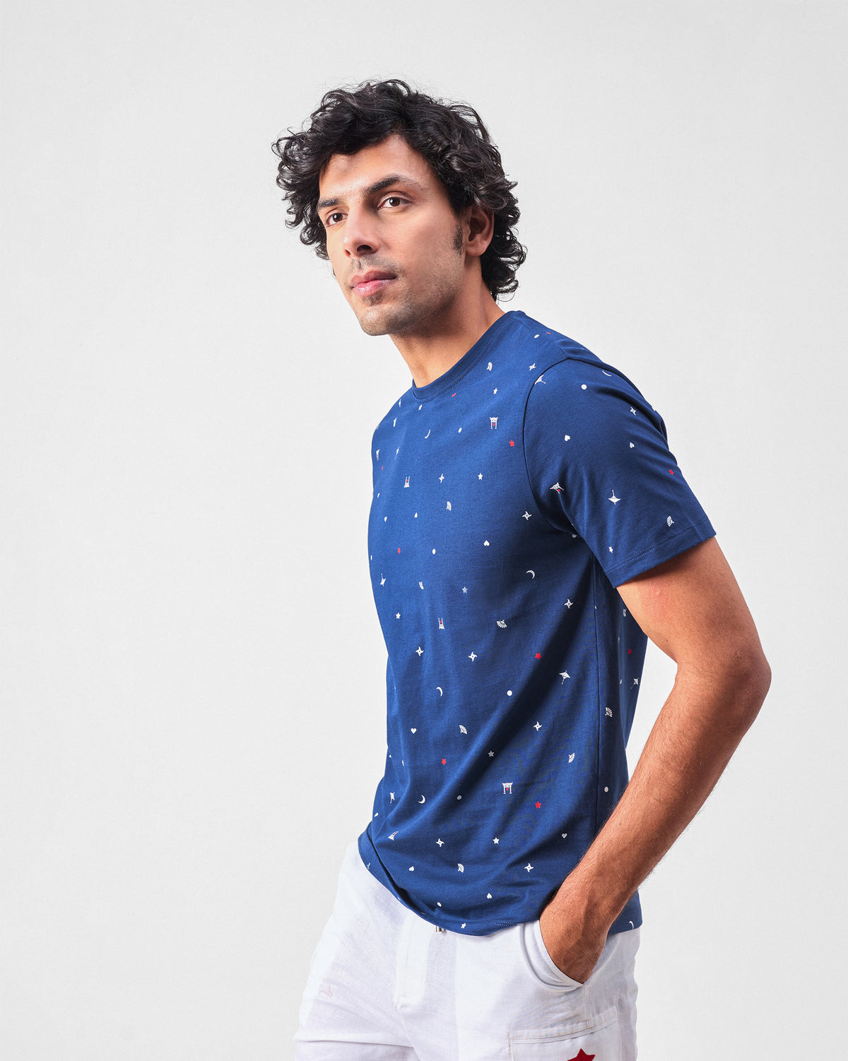 Navy Haruto t-shirt with scattered print worn at a three-quarter angle.