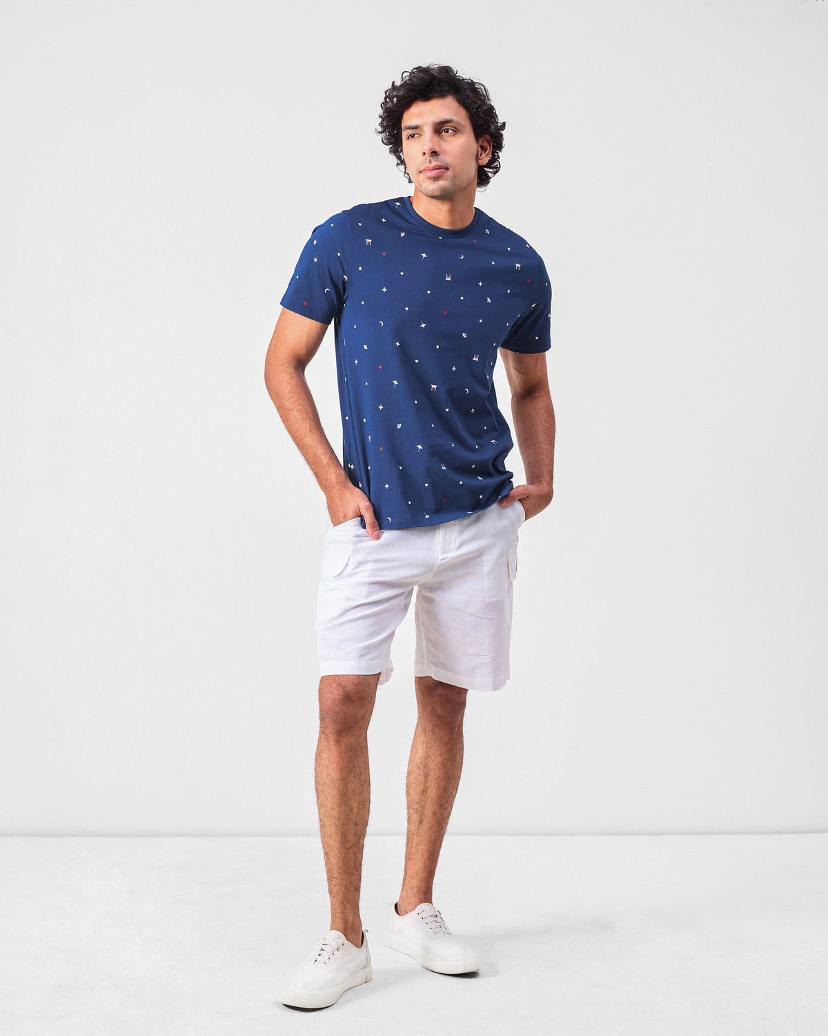 Person wearing a navy printed Haruto t-shirt to mid-hip length.