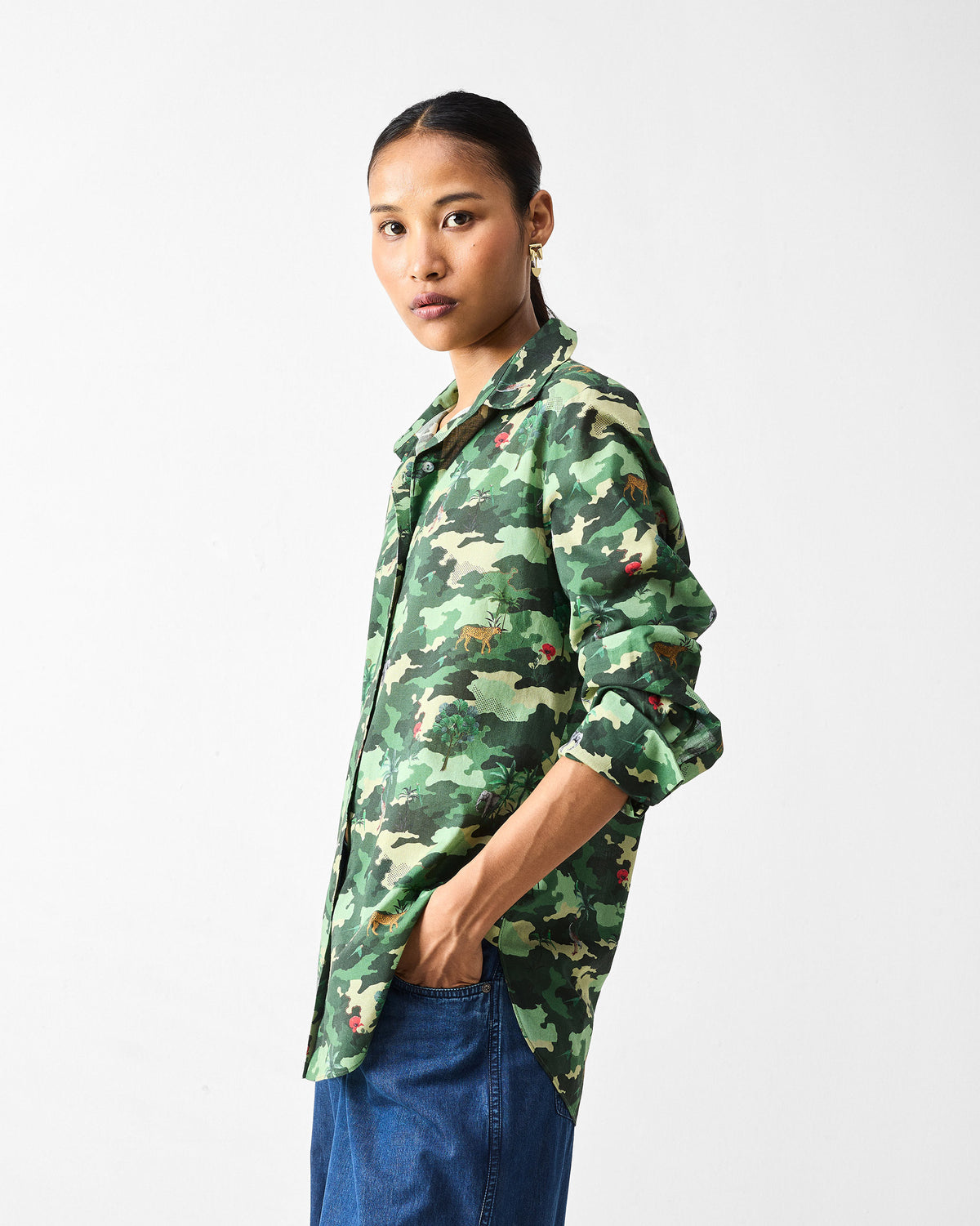 Side view of a green camouflage Tropico Shirt with a relaxed untucked hem.
