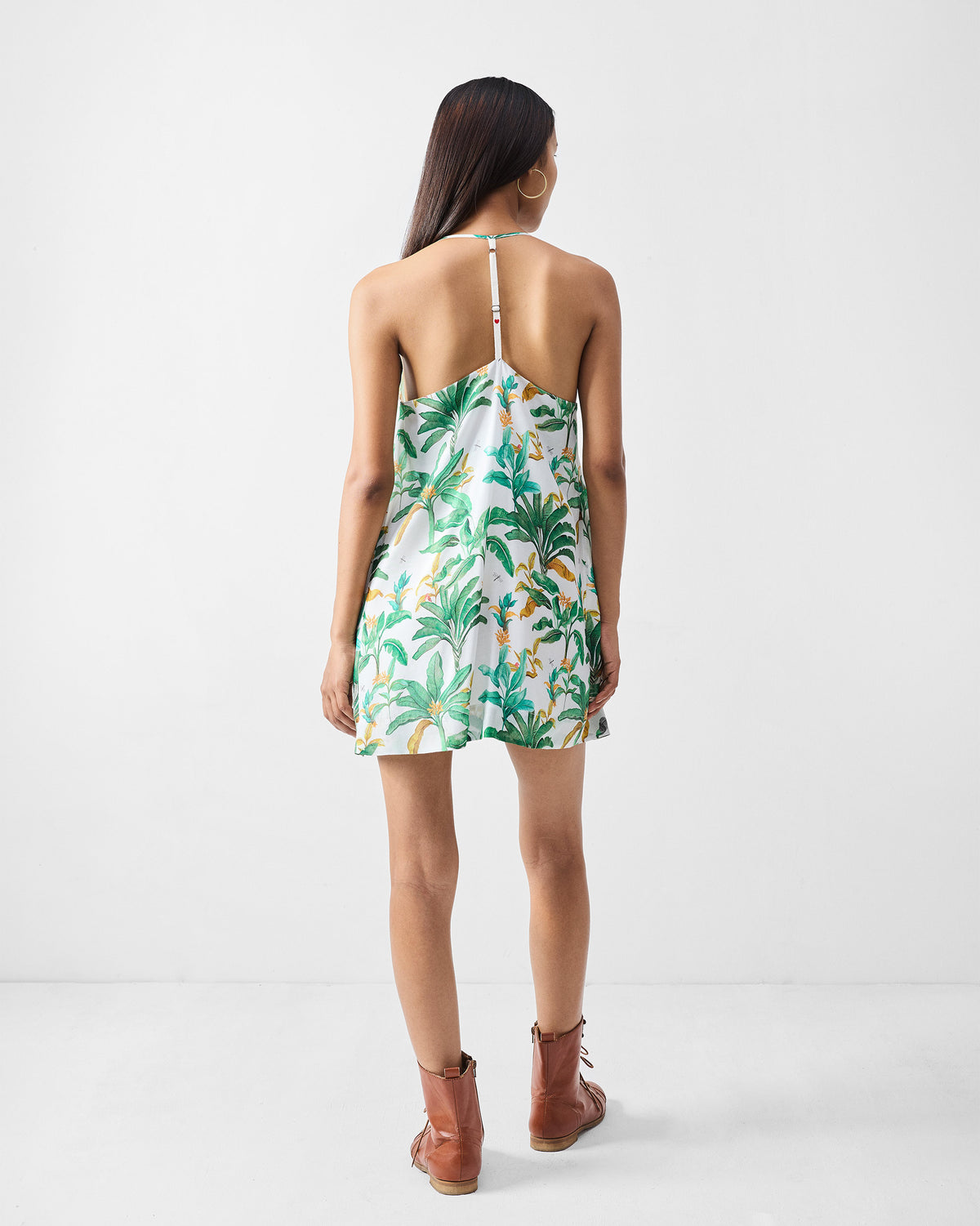 Back of a green printed salem dress with a central T-strap.