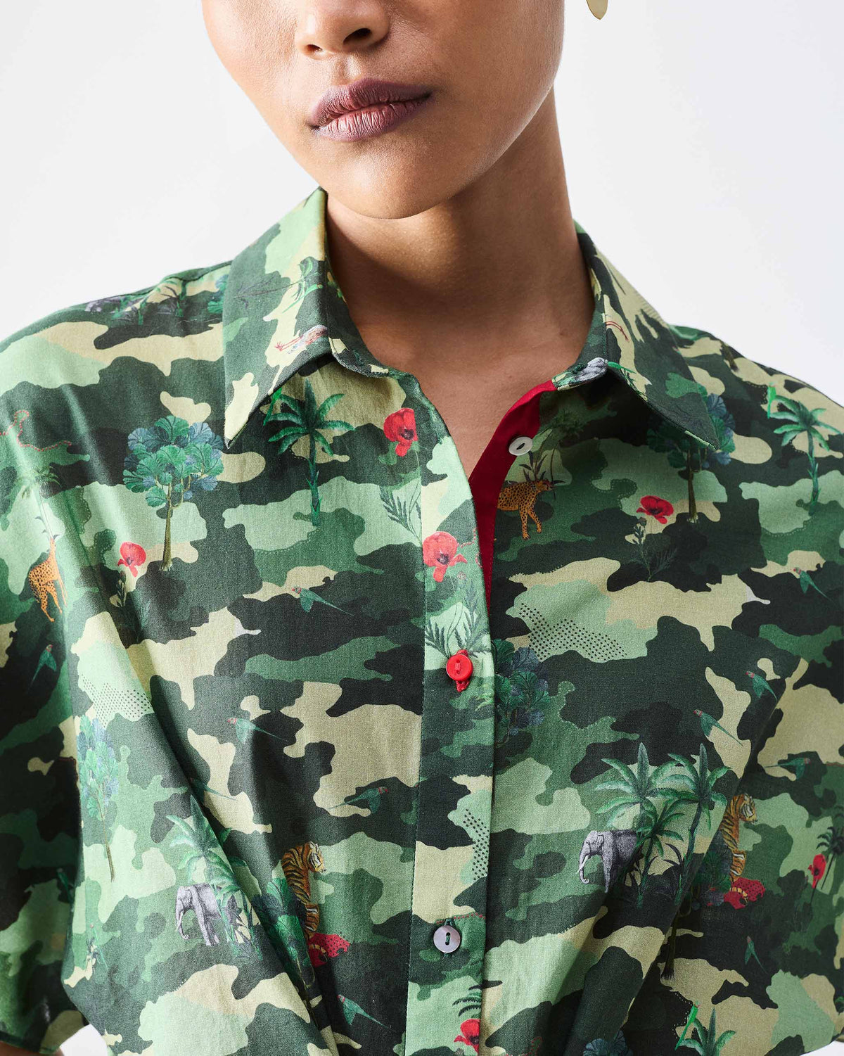 Close-up of a green Alappuzha Shirt Dress showing animal print and red lining.