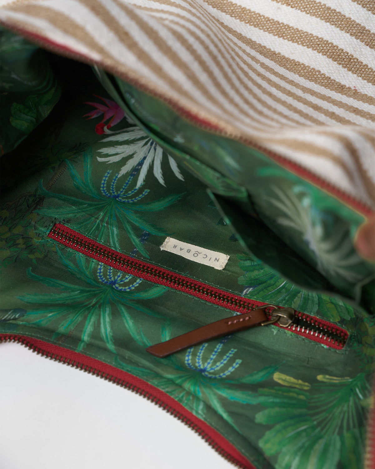 Interior of a Wayfarer bag with a tropical print lining.