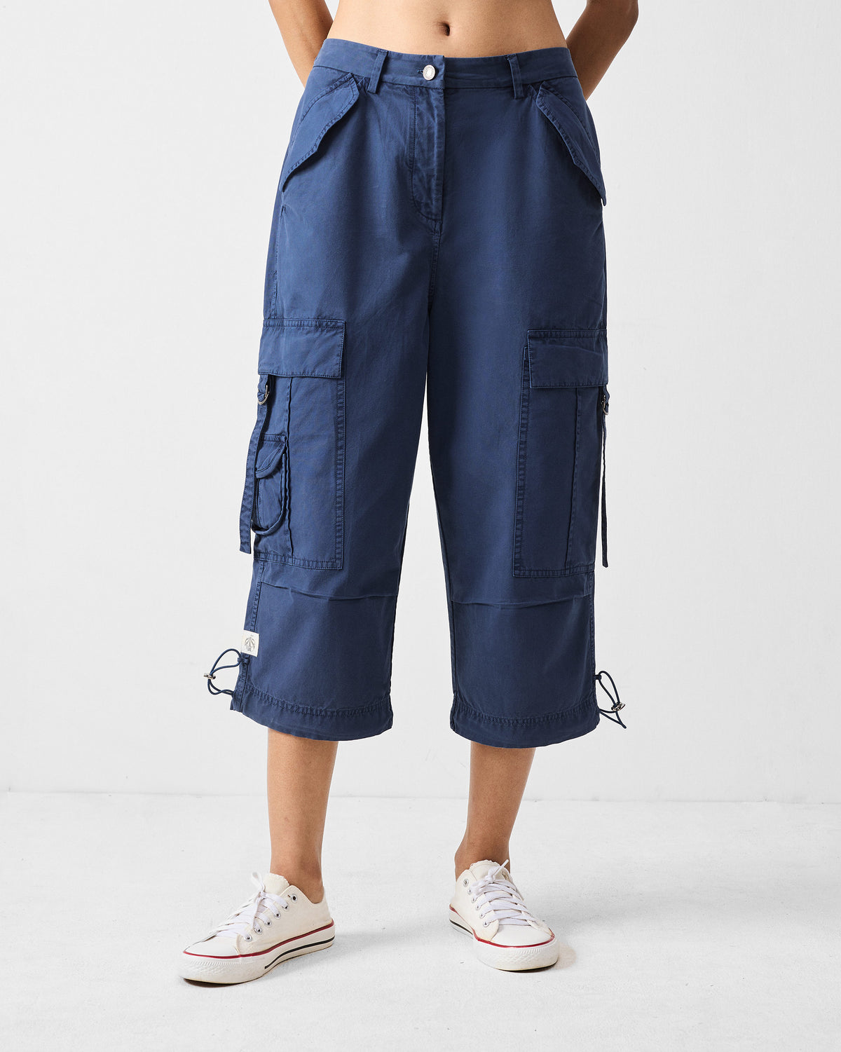 Navy Vellore cargo capris showing thigh pockets and a cropped length.