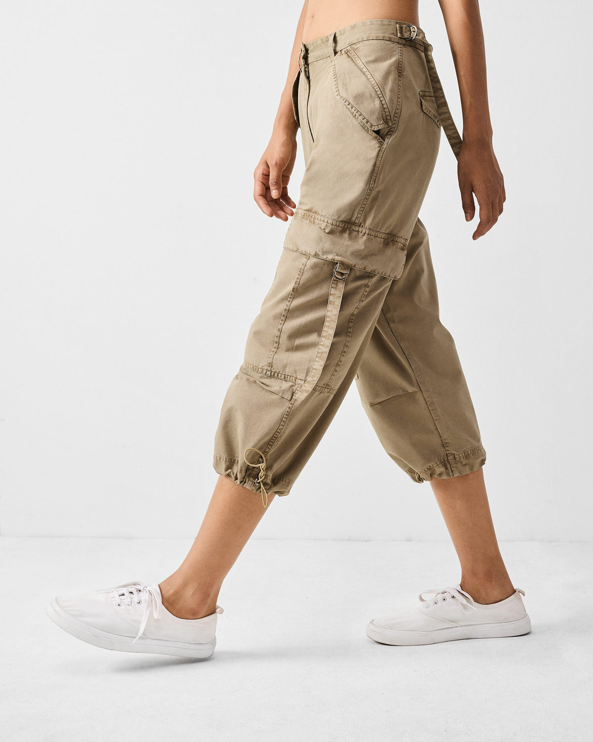 Side view of khaki Vellore Capris showing a cargo pocket and cinched hem.