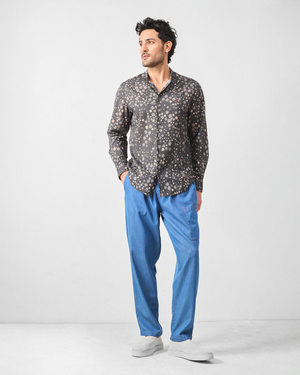 Person wearing a charcoal Nawab Shirt with a Nehru collar and ditsy floral print.