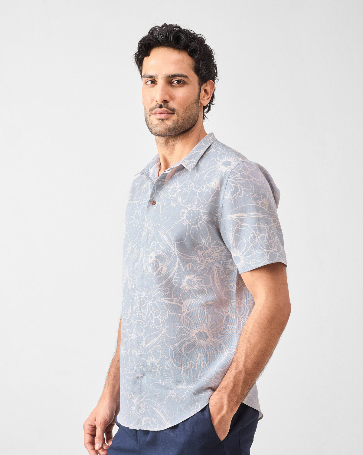 Side view of a grey Riverline shirt with floral print.