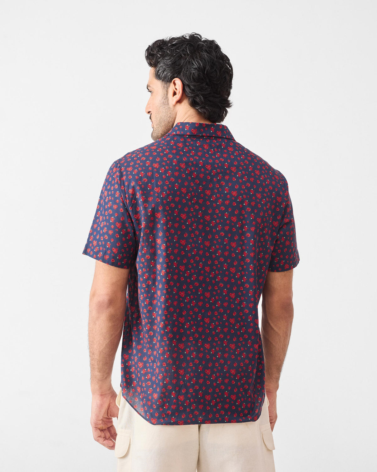 Back of a navy Mistari shirt with an all-over red rose print.