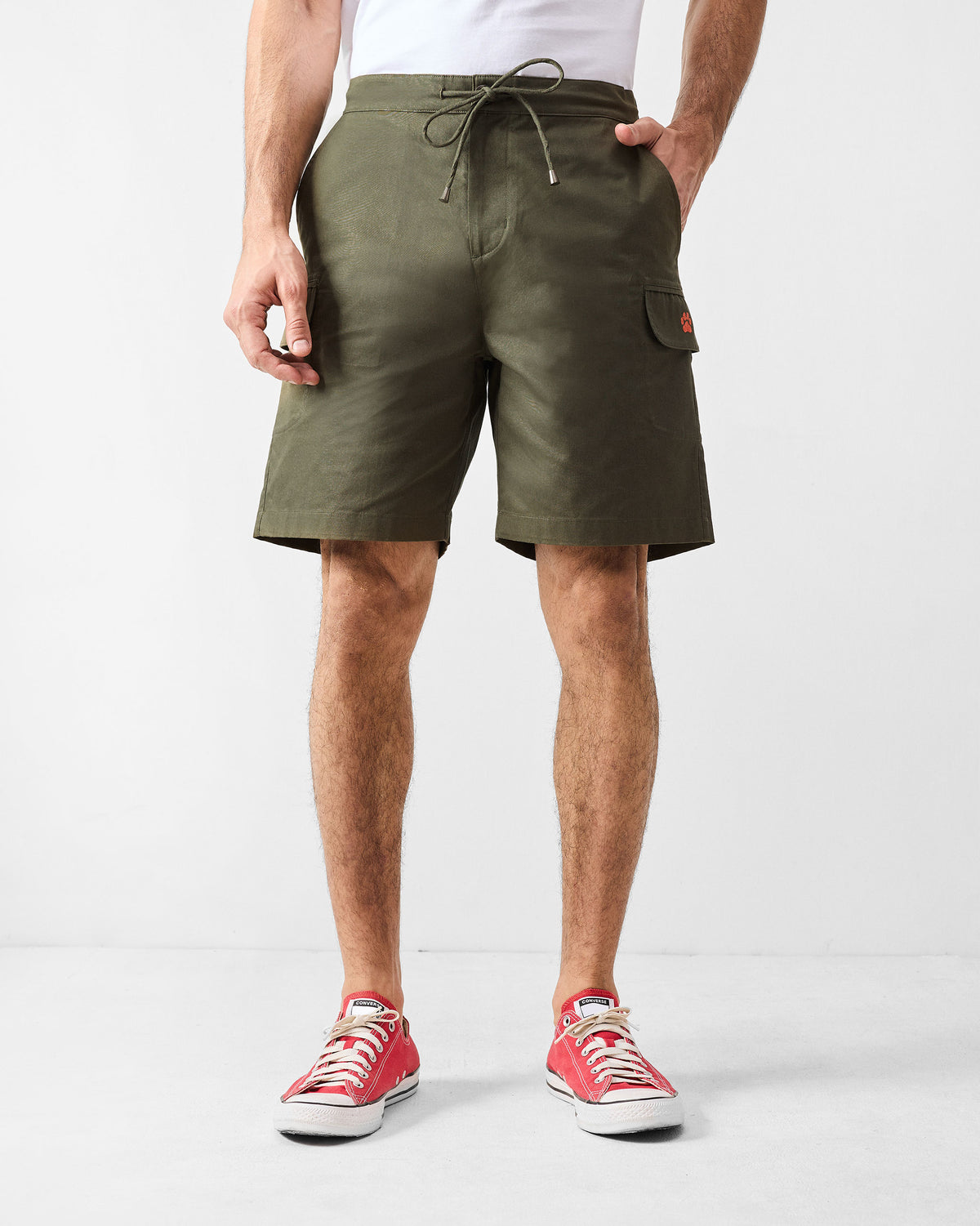 Olive utility shorts with a drawstring waist and cargo pockets.