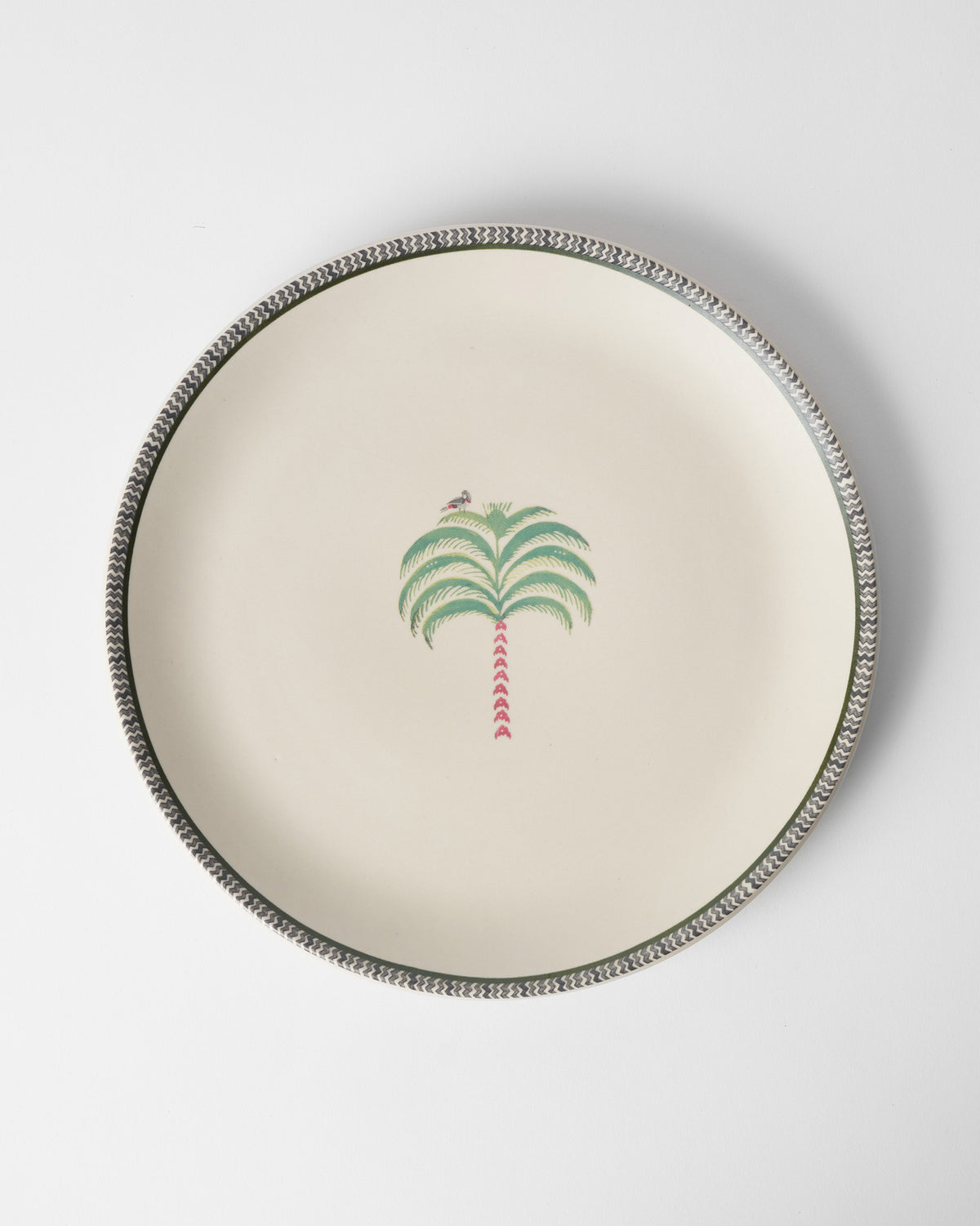 Indus Dinner Plate in cream with a palm motif and a patterned rim.