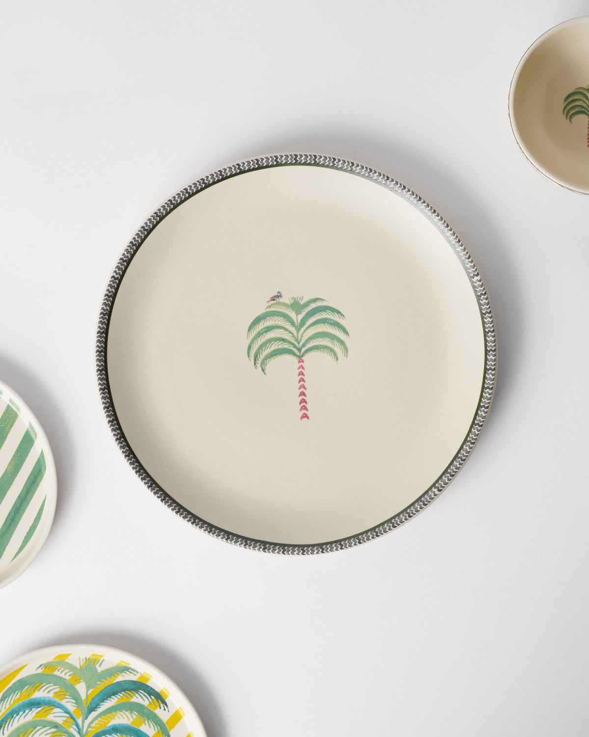 Indus Dinner Plate seen from above, with other tableware around it.