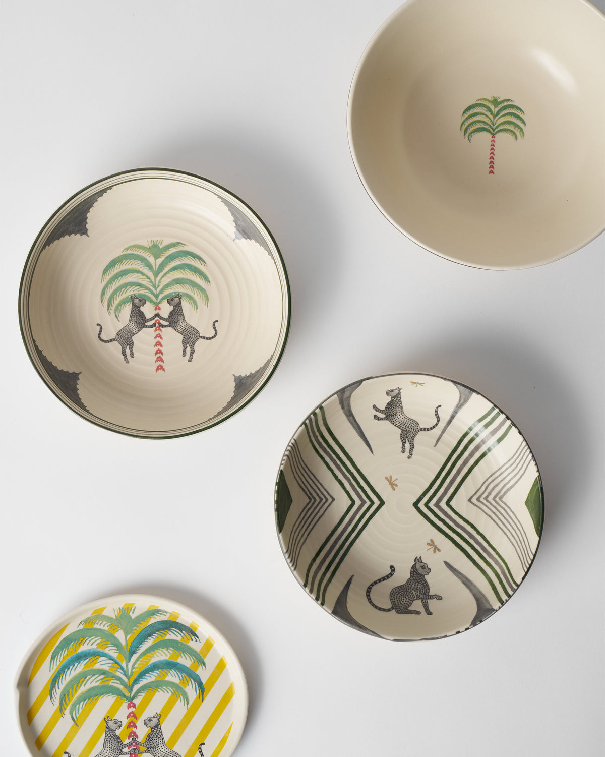 Indus Shallow Bowls with leopard prints among matching ceramic pieces.
