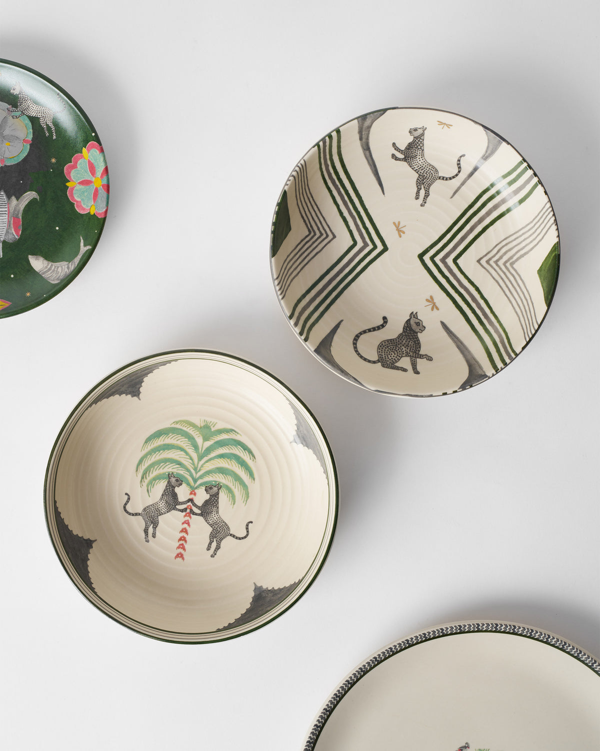 Indus Shallow Bowls with leopard and palm prints seen from above.